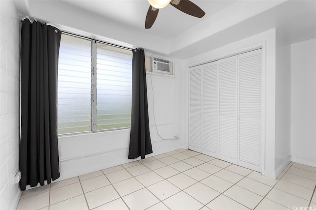 1425 Punahou St Unit 404, Honolulu, HI 96822 - unfurnished bedroom with a closet, ceiling fan, an AC wall unit, and light tile patterned floors