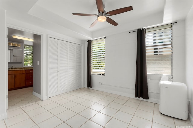 1425 Punahou St Unit 404, Honolulu, HI 96822 - unfurnished bedroom featuring a closet, a ceiling fan, and light tile patterned floors
