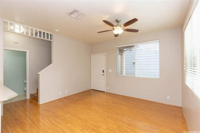 91-1001 Keaunui Dr Unit 106, Ewa Beach, HI 96706 - empty room with light wood-style floors, a ceiling fan, and stairs