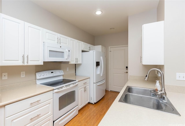 91-1001 Keaunui Dr Unit 106, Ewa Beach, HI 96706 - kitchen with white appliances, white cabinets, light wood-type flooring, light countertops, and recessed lighting