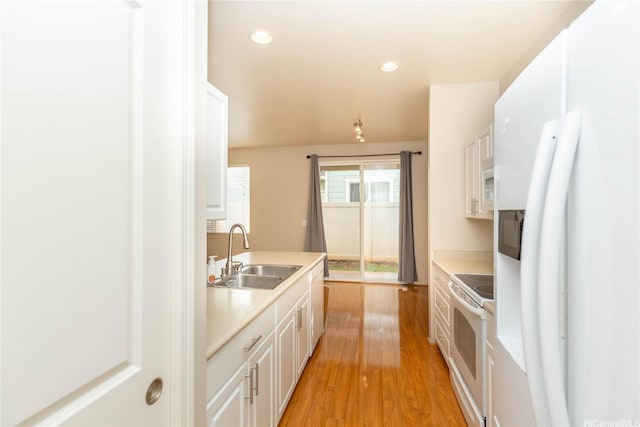 91-1001 Keaunui Dr Unit 106, Ewa Beach, HI 96706 - kitchen featuring white appliances, light countertops, white cabinetry, light wood finished floors, and recessed lighting