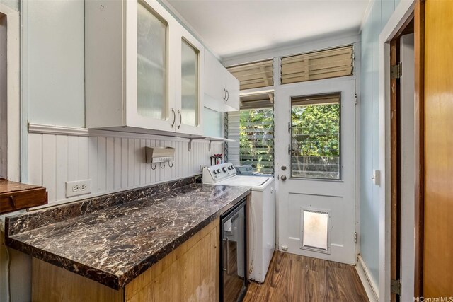 259 N Kalaheo Ave Unit A, Kailua, HI 96734 - kitchen with washer and clothes dryer, dark wood-type flooring, glass insert cabinets, white cabinets, and dark stone counters