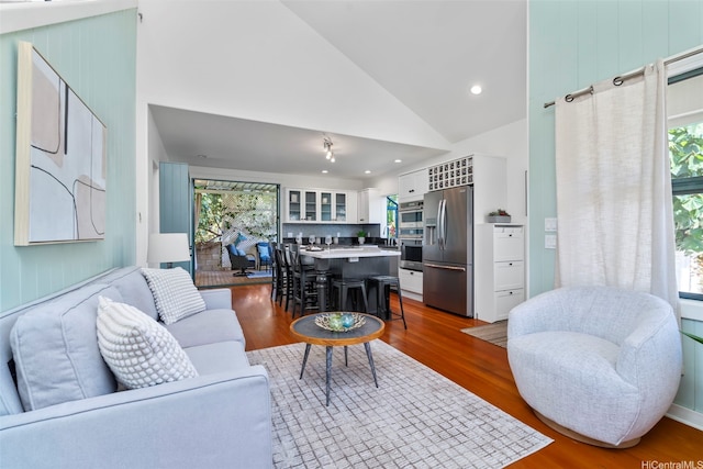 2633B Nahaku Pl Unit H, Honolulu, HI 96826 - living area featuring dark wood-style flooring, high vaulted ceiling, and recessed lighting