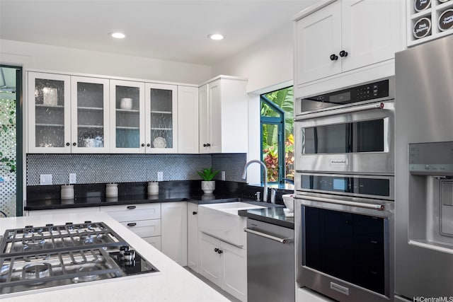 2633B Nahaku Pl Unit H, Honolulu, HI 96826 - kitchen with stainless steel appliances, white cabinets, backsplash, glass insert cabinets, and recessed lighting