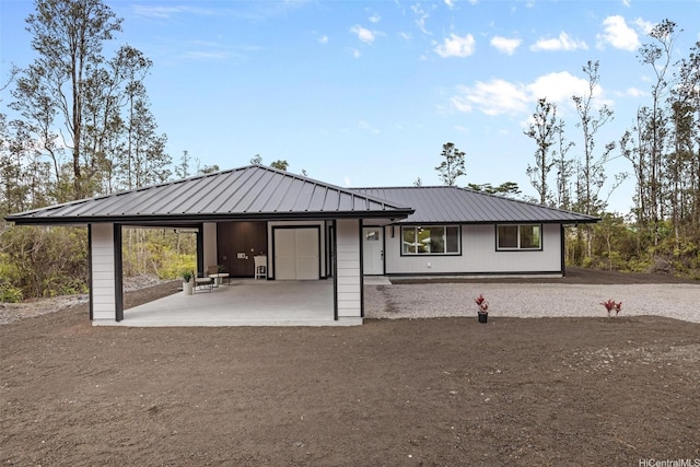 16-2073 Plumeria Dr, Pahoa, HI 96778 - view of front facade with a metal roof and a patio area
