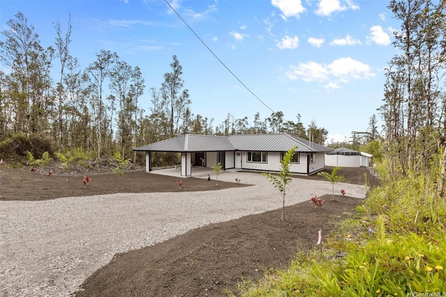 16-2073 Plumeria Dr, Pahoa, HI 96778 - view of front facade featuring dirt driveway, an attached carport, and a metal roof