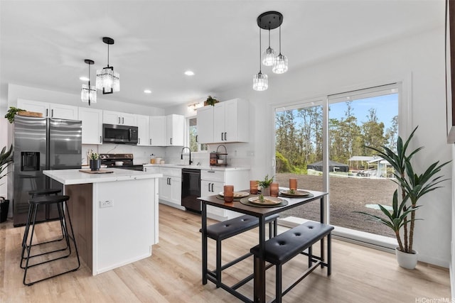 16-2073 Plumeria Dr, Pahoa, HI 96778 - kitchen with appliances with stainless steel finishes, light countertops, light wood-style flooring, a center island, and recessed lighting