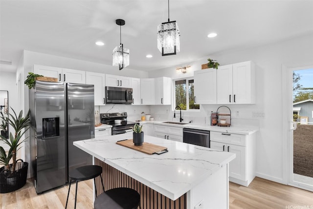 16-2073 Plumeria Dr, Pahoa, HI 96778 - kitchen with black appliances, plenty of natural light, light wood-style flooring, white cabinetry, and recessed lighting