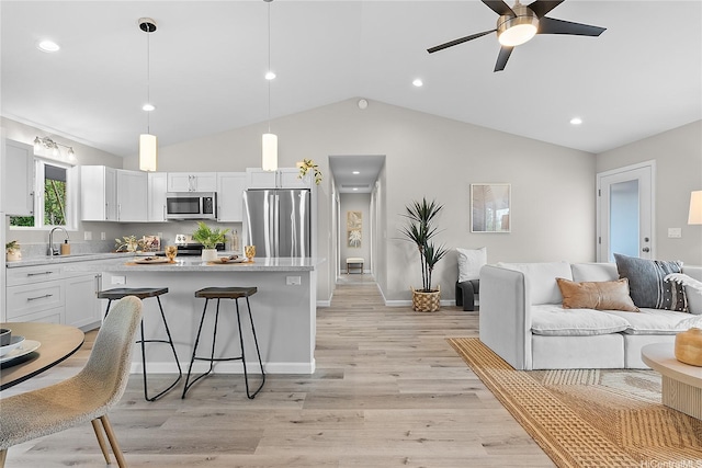 16-2154 Coral Dr, Pahoa, HI 96778 - kitchen with stainless steel appliances, open floor plan, a center island, a kitchen breakfast bar, and light countertops