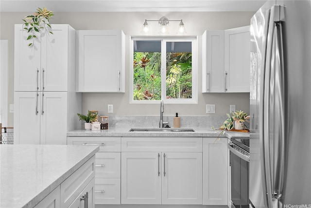 16-2154 Coral Dr, Pahoa, HI 96778 - kitchen with stainless steel appliances, white cabinetry, and light stone counters
