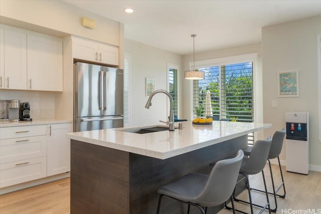 520 Lunalilo Home Rd Unit 354, Honolulu, HI 96825 - kitchen with freestanding refrigerator, light wood finished floors, white cabinetry, a breakfast bar area, and recessed lighting