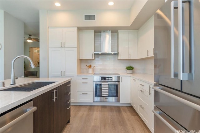 520 Lunalilo Home Rd Unit 354, Honolulu, HI 96825 - kitchen featuring stainless steel appliances, wall chimney range hood, white cabinetry, and recessed lighting