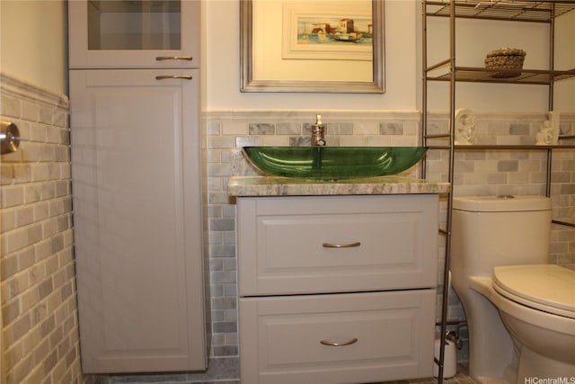 425 Ena Rd Unit 407B, Honolulu, HI 96815 - bathroom featuring tile walls, vanity, and wainscoting