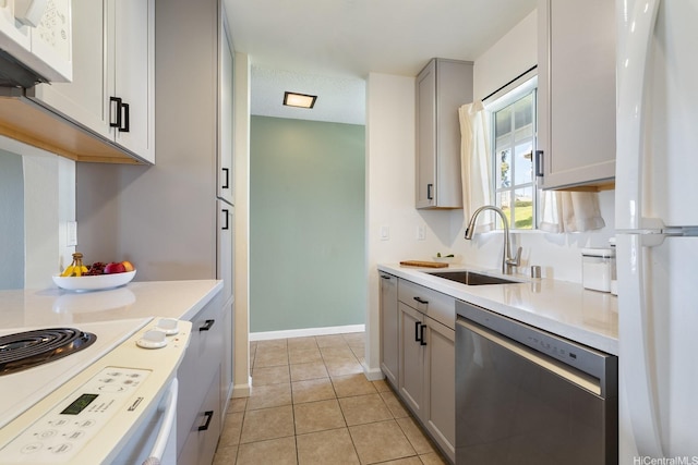 92-1005 Nou St Unit 5103, Kapolei, HI 96707 - kitchen with stainless steel dishwasher, freestanding refrigerator, gray cabinets, light countertops, and light tile patterned floors