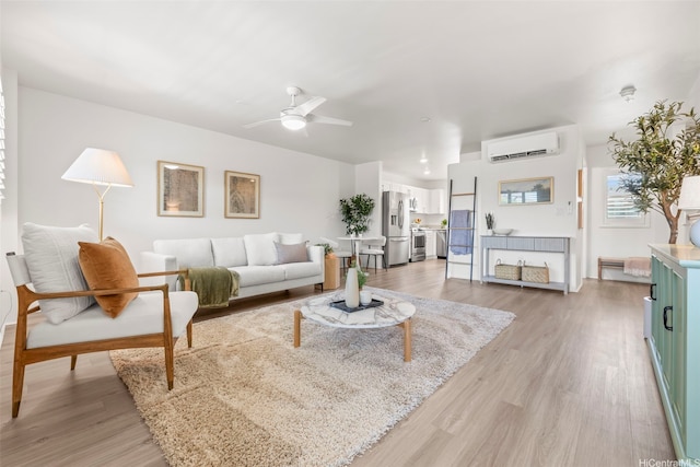 91-3633 Kauluakoko St Unit 1004, Ewa Beach, HI 96706 - living room featuring an AC wall unit, a ceiling fan, and light wood-type flooring