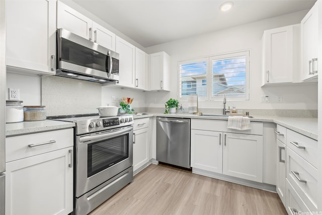 91-3633 Kauluakoko St Unit 1004, Ewa Beach, HI 96706 - kitchen with appliances with stainless steel finishes, white cabinetry, light wood-style flooring, and recessed lighting