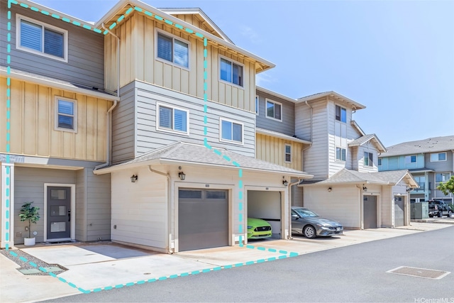 91-3633 Kauluakoko St Unit 1004, Ewa Beach, HI 96706 - view of building exterior with an attached garage and driveway