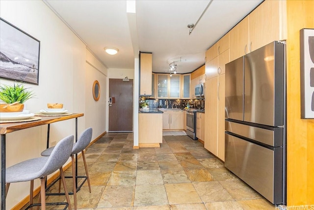 303 Liliuokalani Ave Unit 1102, Honolulu, HI 96815 - kitchen featuring appliances with stainless steel finishes, light brown cabinets, light stone finish flooring, and dark countertops