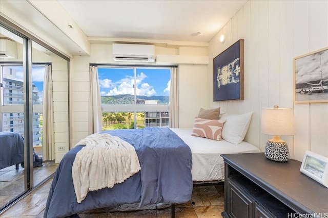 303 Liliuokalani Ave Unit 1102, Honolulu, HI 96815 - bedroom with an AC wall unit, light stone finish floors, access to exterior, and a wall unit AC