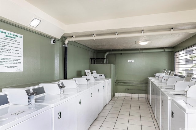 2211 Ala Wai Blvd Unit 3201, Honolulu, HI 96815 - shared laundry featuring independent washer and dryer and light tile patterned floors