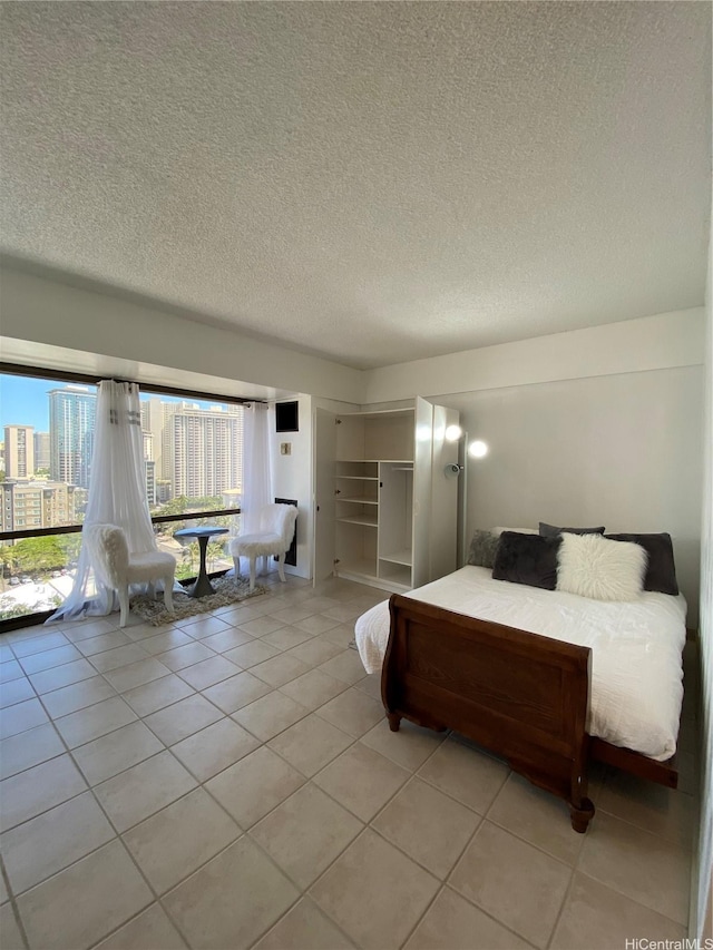 1750 Kalakaua Ave Unit 1507, Honolulu, HI 96826 - bedroom featuring light tile patterned flooring and a textured ceiling