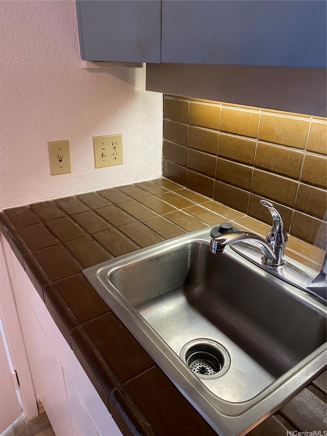 1750 Kalakaua Ave Unit 1507, Honolulu, HI 96826 - kitchen view of backsplash, a textured wall, and tile countertops