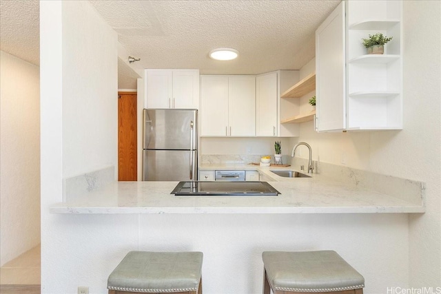 300 Wai Nani Way Unit 1715, Honolulu, HI 96815 - kitchen featuring freestanding refrigerator, open shelves, a textured ceiling, a peninsula, and white cabinetry