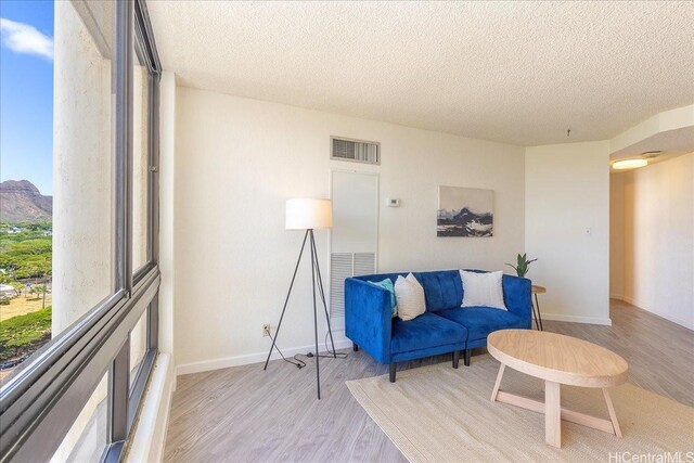 300 Wai Nani Way Unit 1715, Honolulu, HI 96815 - living area with light wood-type flooring and a textured ceiling