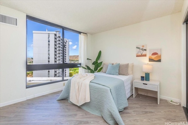 300 Wai Nani Way Unit 1715, Honolulu, HI 96815 - bedroom featuring wood finished floors and floor to ceiling windows