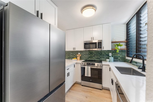 333 Aoloa St Unit 214, Kailua, HI 96734 - kitchen featuring stainless steel appliances, white cabinets, decorative backsplash, and light stone countertops