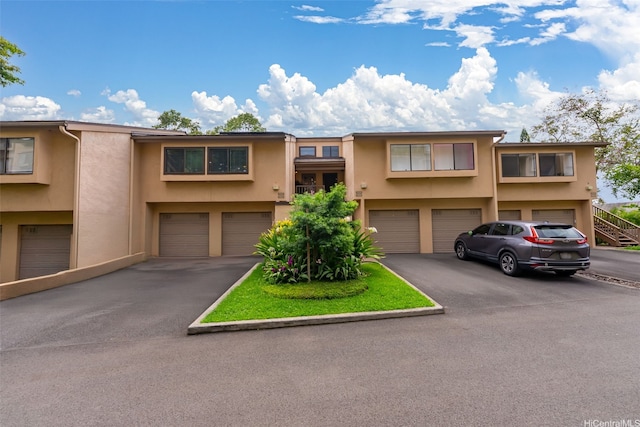 46-036 Aliikane Pl Unit 522, Kaneohe, HI 96744 - townhome / multi-family property featuring stucco siding, an attached garage, and driveway
