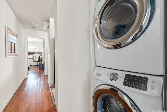 46-036 Aliikane Pl Unit 522, Kaneohe, HI 96744 - laundry room with stacked washer / dryer and wood-type flooring