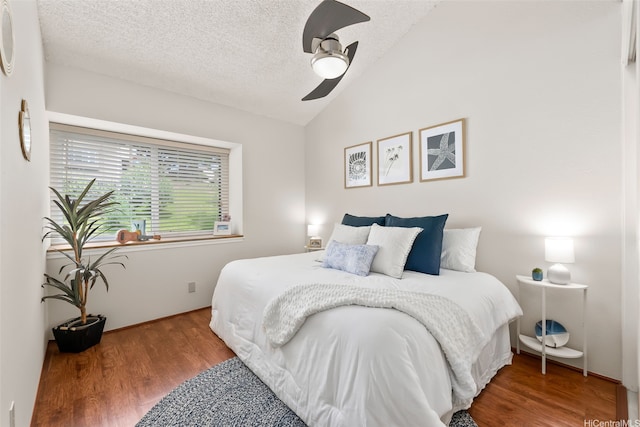46-036 Aliikane Pl Unit 522, Kaneohe, HI 96744 - bedroom with vaulted ceiling, wood finished floors, a textured ceiling, and ceiling fan