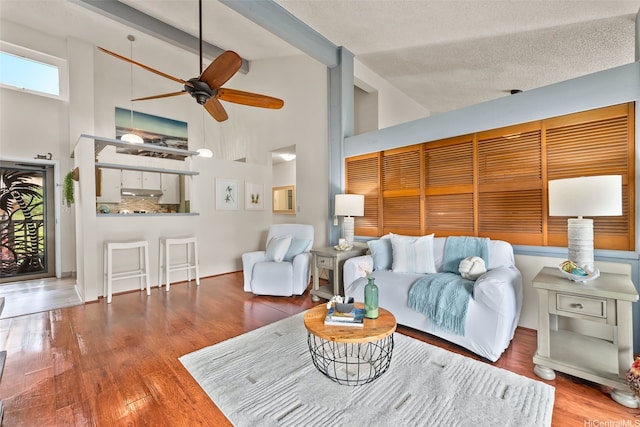46-036 Aliikane Pl Unit 522, Kaneohe, HI 96744 - living room featuring high vaulted ceiling, ceiling fan, wood finished floors, and beamed ceiling