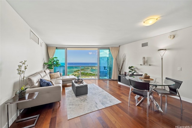 1177 Queen St Unit 4104, Honolulu, HI 96814 - living area with a wall of windows, wood finished floors, and a water view