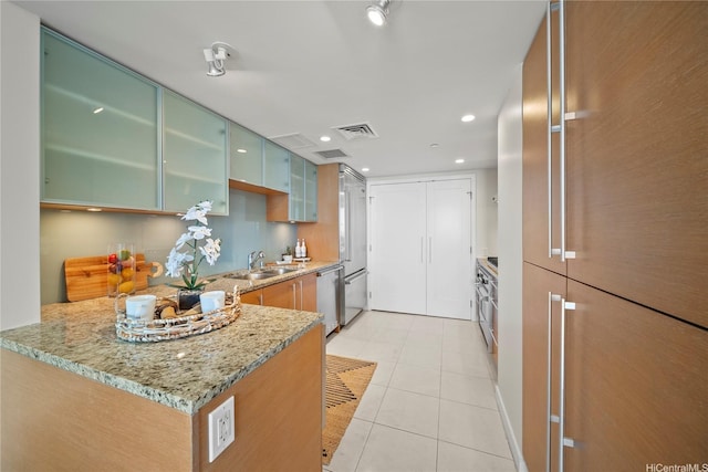 1177 Queen St Unit 4104, Honolulu, HI 96814 - kitchen featuring dishwasher, light tile patterned floors, light stone counters, glass insert cabinets, and recessed lighting