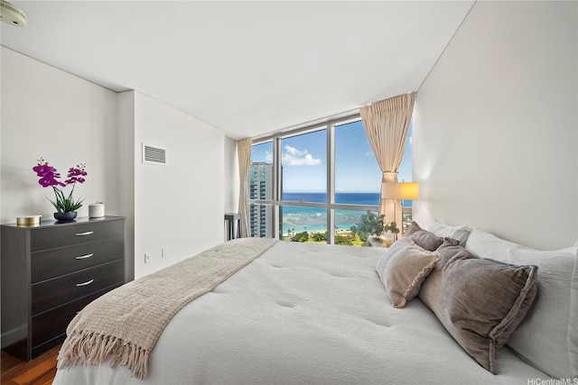 1177 Queen St Unit 4104, Honolulu, HI 96814 - bedroom featuring a water view, expansive windows, and wood finished floors