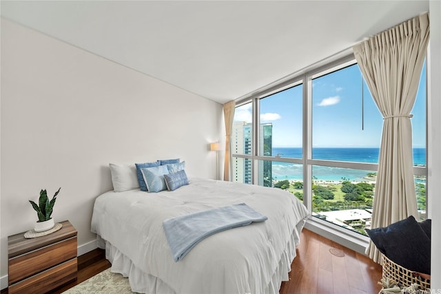 1177 Queen St Unit 4104, Honolulu, HI 96814 - bedroom with multiple windows, a water view, wood finished floors, and floor to ceiling windows