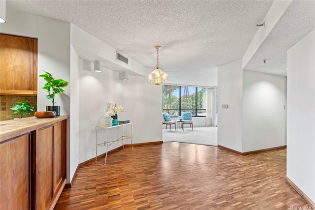 1525 Wilder Ave Unit 401, Honolulu, HI 96822 - unfurnished dining area featuring wood finished floors, a textured ceiling, and a chandelier