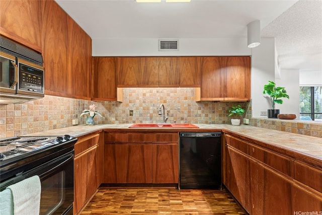 1525 Wilder Ave Unit 401, Honolulu, HI 96822 - kitchen featuring black dishwasher, electric range, stainless steel microwave, and light countertops