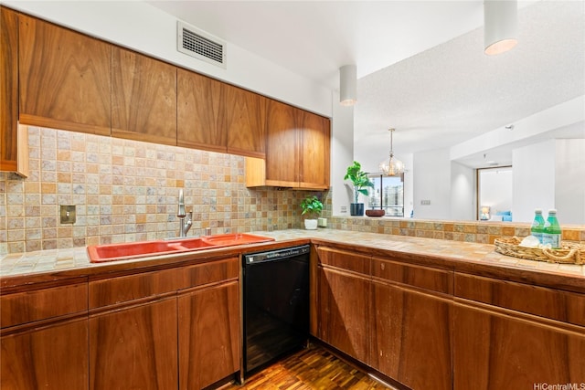 1525 Wilder Ave Unit 401, Honolulu, HI 96822 - kitchen with dishwasher, tile countertops, brown cabinets, and decorative backsplash
