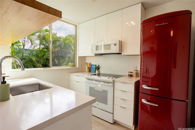 3721 Kanaina Ave Unit 201, Honolulu, HI 96815 - kitchen featuring white appliances, light countertops, and white cabinets