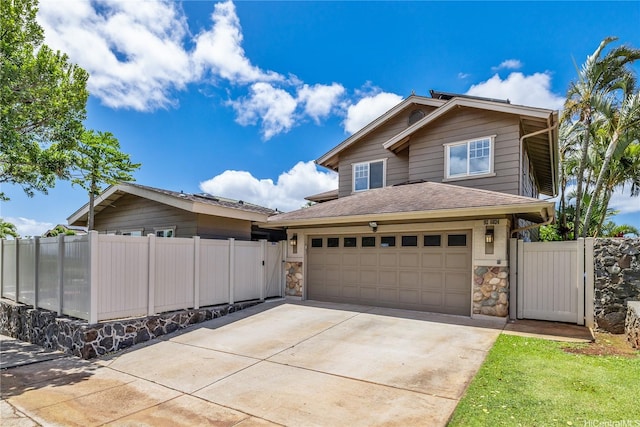 92-6024 Kohi St, Kapolei, HI 96707 - view of front of house featuring concrete driveway, a gate, stone siding, and a shingled roof