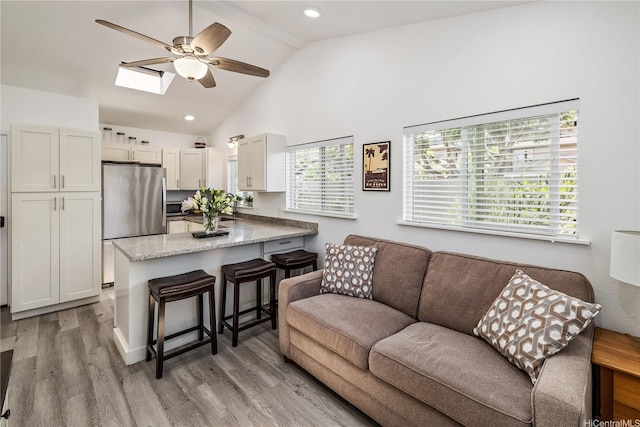 92-6024 Kohi St, Kapolei, HI 96707 - living area with a ceiling fan, light wood-style flooring, a skylight, recessed lighting, and high vaulted ceiling