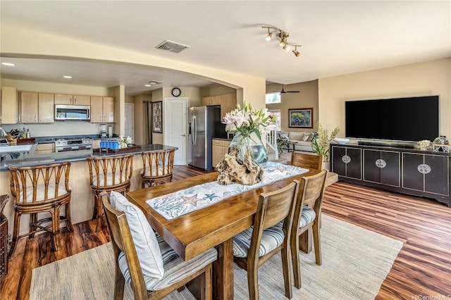 92-6024 Kohi St, Kapolei, HI 96707 - dining area with ceiling fan, dark wood finished floors, arched walkways, and recessed lighting