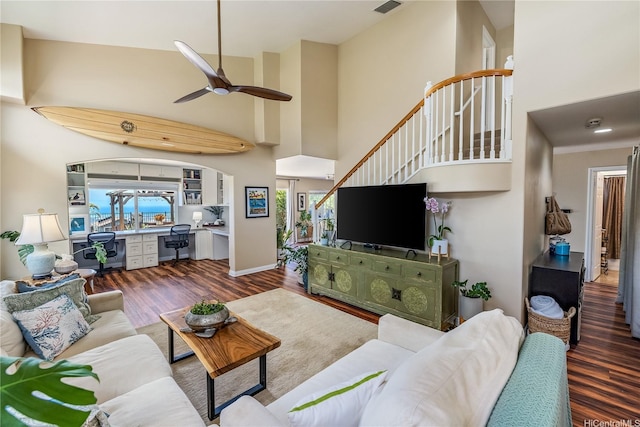 92-6024 Kohi St, Kapolei, HI 96707 - living room with wood finished floors, a high ceiling, a ceiling fan, and stairs