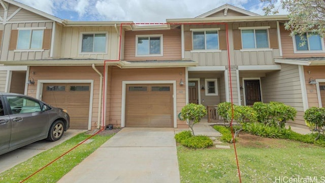 801 Kakala St Unit 1904, Kapolei, HI 96707 - view of property featuring board and batten siding, driveway, and a garage