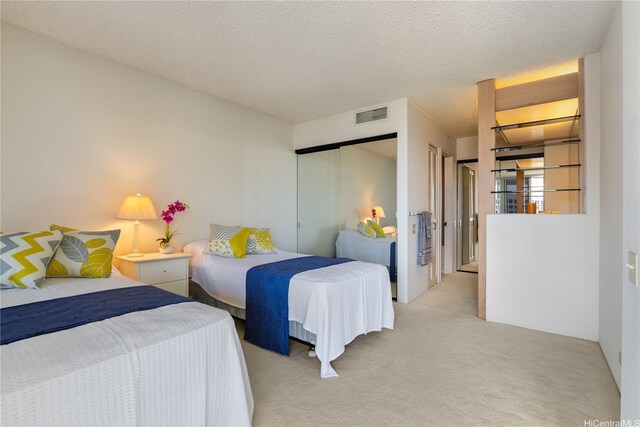 1212 Nuuanu Ave Unit 3402, Honolulu, HI 96817 - bedroom with light colored carpet, multiple closets, and a textured ceiling