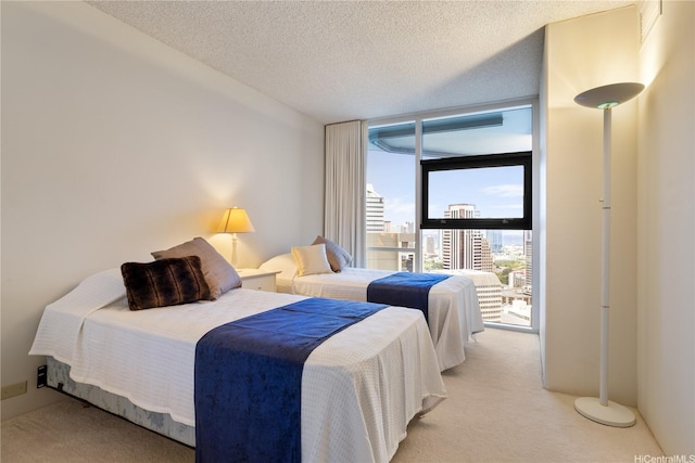 1212 Nuuanu Ave Unit 3402, Honolulu, HI 96817 - bedroom featuring carpet, a wall of windows, and a textured ceiling