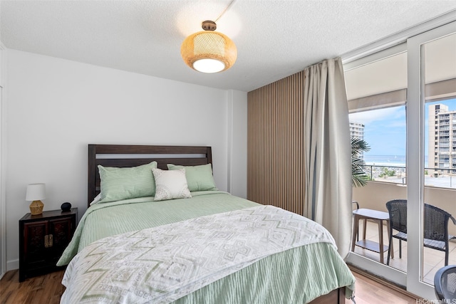 1720 Ala Moana Blvd Unit 1101B, Honolulu, HI 96815 - bedroom featuring wood finished floors and a textured ceiling